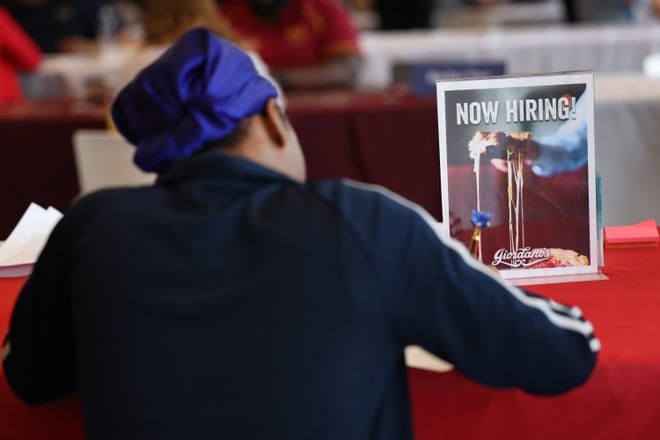 A job seeker fills out an application during a job fair at Navy Pier in Chicago,