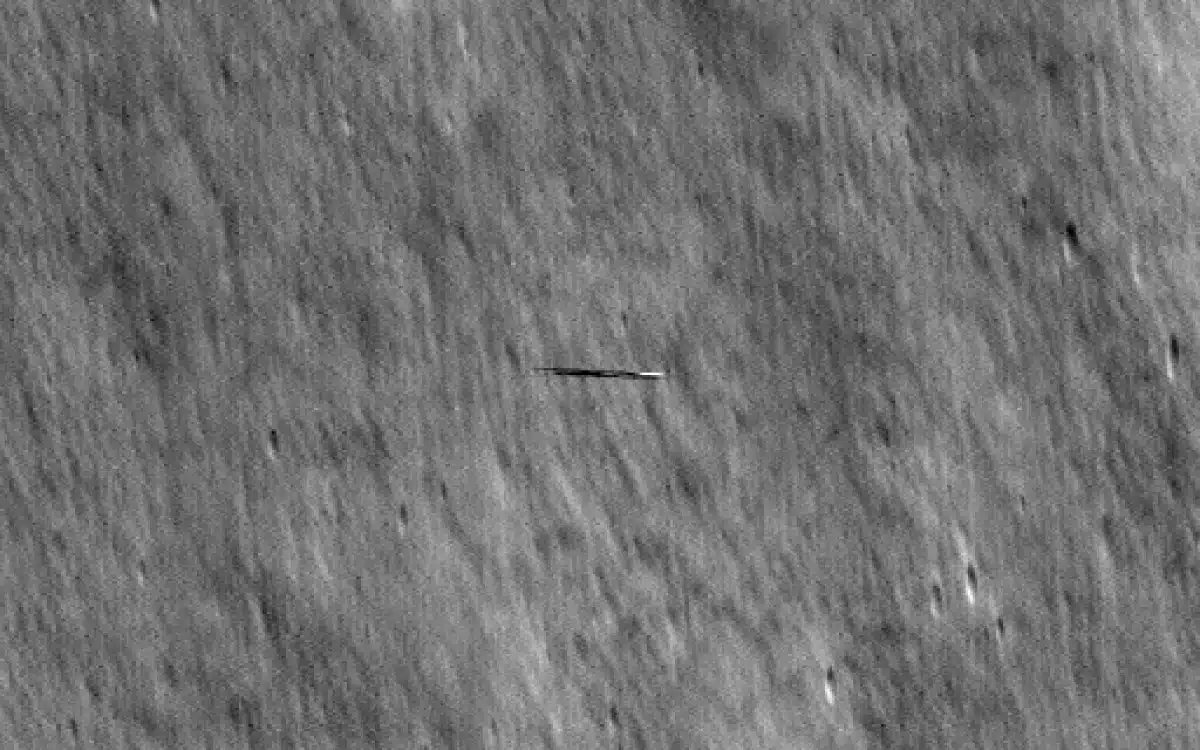 NASA reveals images of surfboard-shaped object orbiting moon